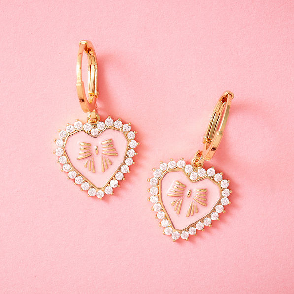 rhinestone heart earrings on pink paper