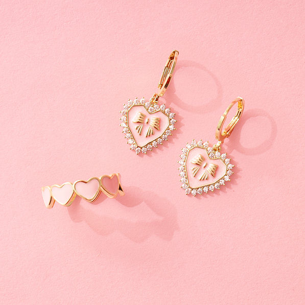 rhinestone heart earrings with heart ring on pink paper
