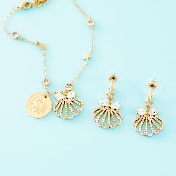 gold shell bracelet on blue background