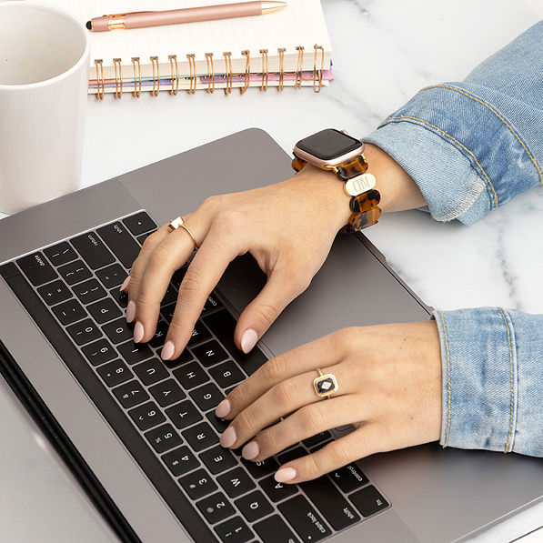 tortoise scallop watch band on wrist typing