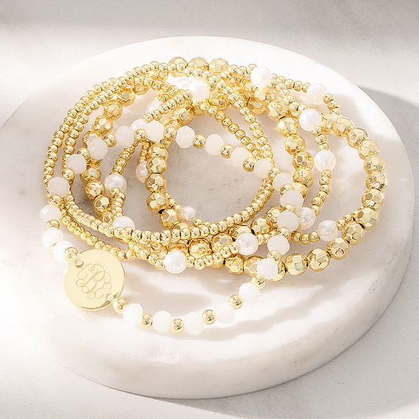 gold beaded monogrammed bracelet stack on marble