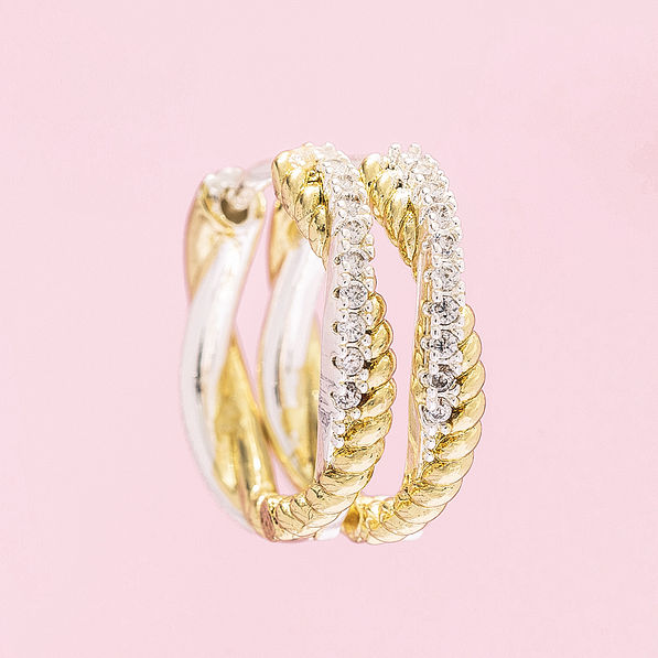 silver and gold pave cable hoop earrings on pink background