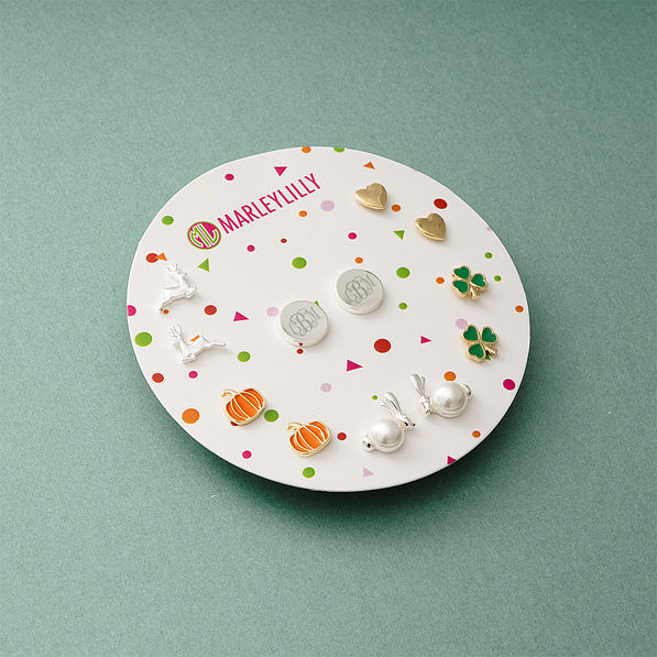 monogrammed year round earring set on green paper