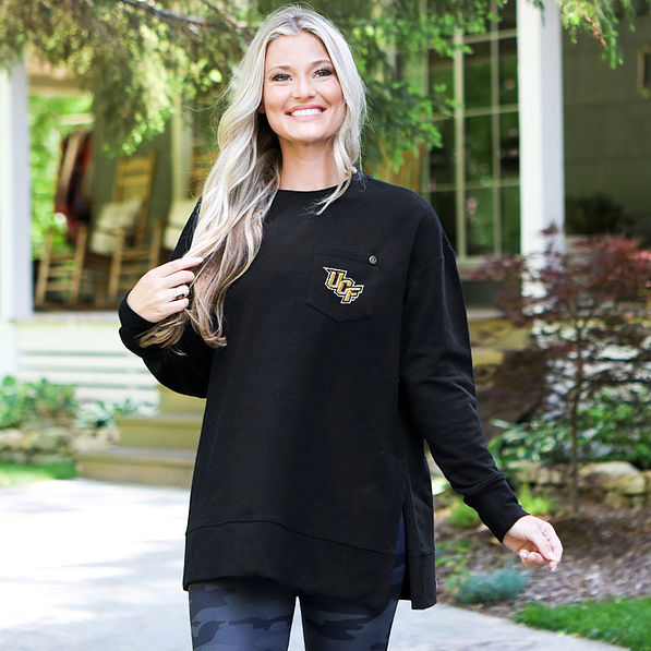 ucf black crewneck sweatshirt on blonde girl by cabin
