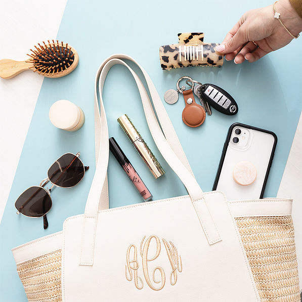 brown airtag key chain with seaside tote and hair clip