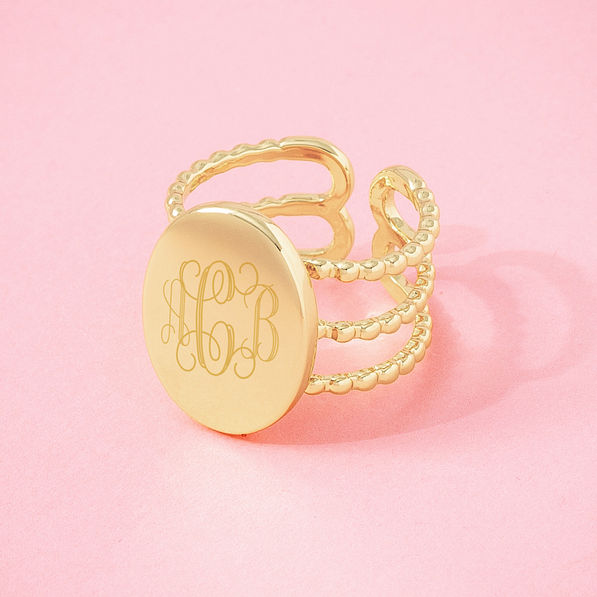 gold statement personalized ring on pink background