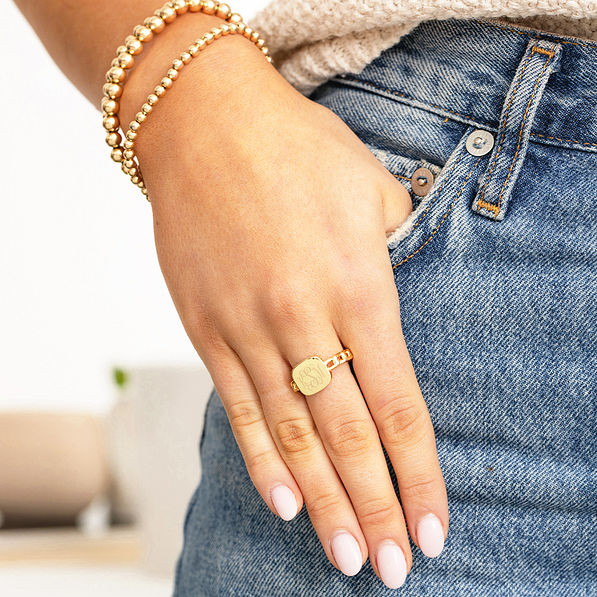 gold chain link ring with hand in pocket