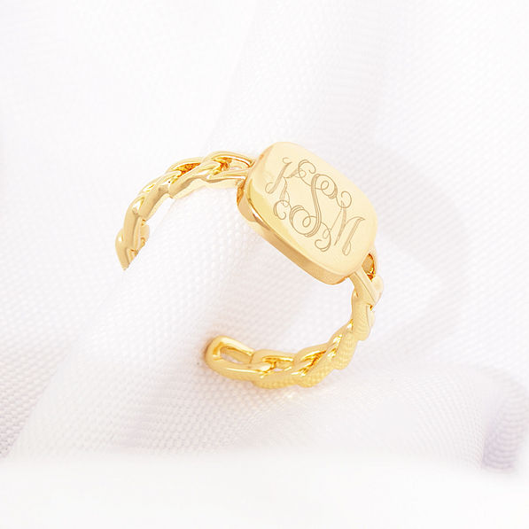 gold chain link ring on white cloth