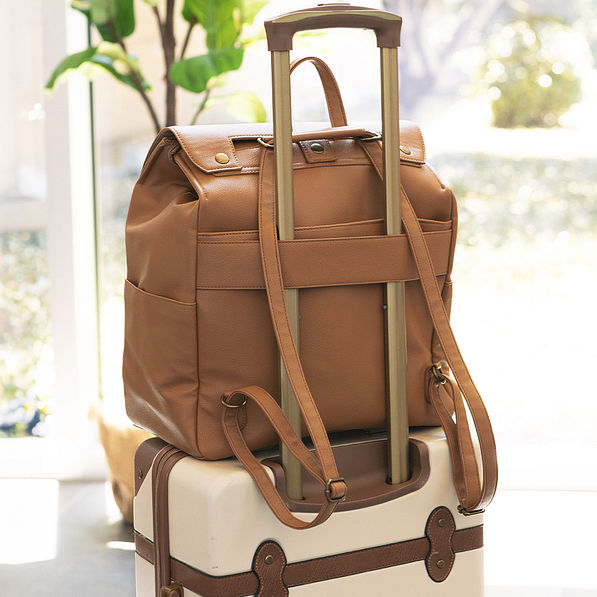 monogrammed diaper backpack purse on suitcase