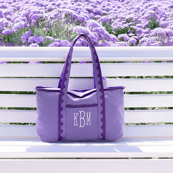 purple anywhere tote bag on bench with flowers