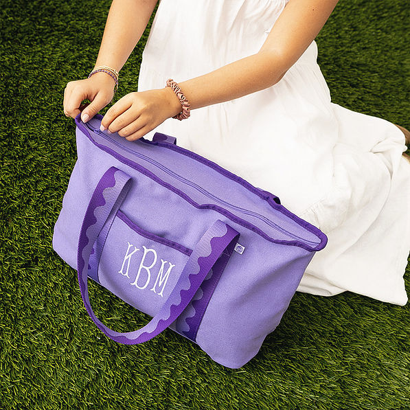 purple anywhere tote bag on grass