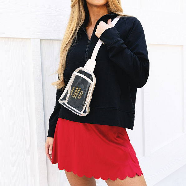 girl with skort with personalized bone sling pack over shoulder