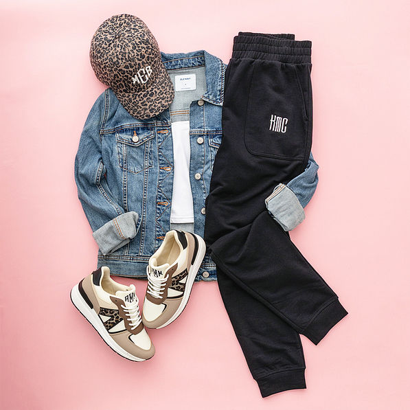 black sweatshirt joggers flatlay on pink background