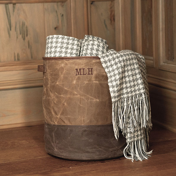 waxed canvas storage basket with blankets hanging out