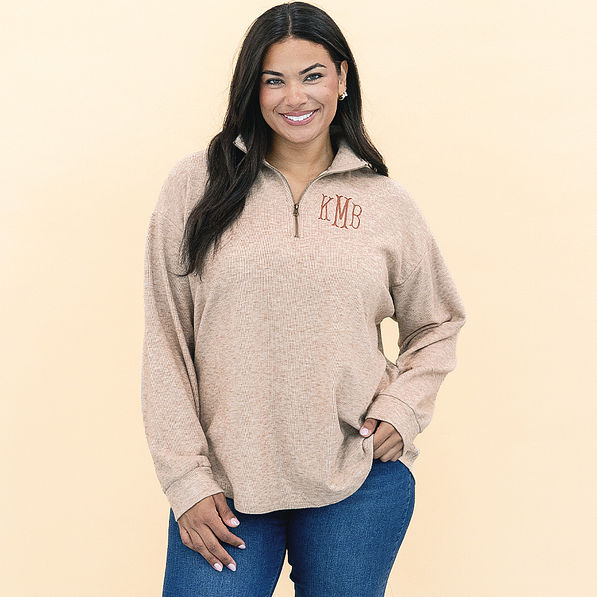 girl wearing personalized heathered fleece pullover in tan