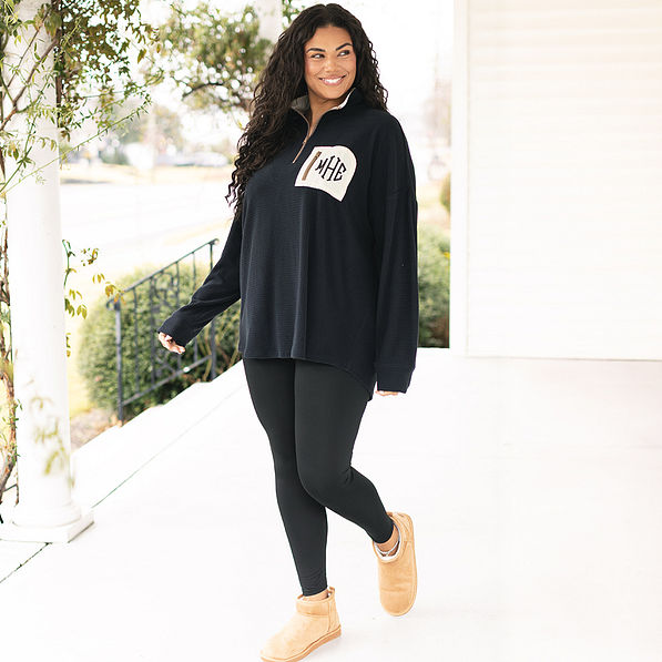 girl wearing black grid fleece pullover with leggings