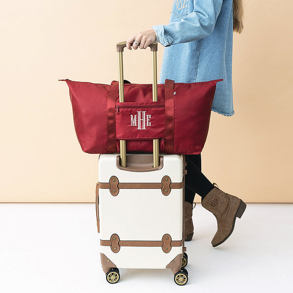 crimson personalized carry on weekender bag on luggage with strap
