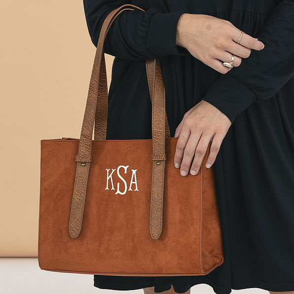 monogrammed suede purse over arm fishtail