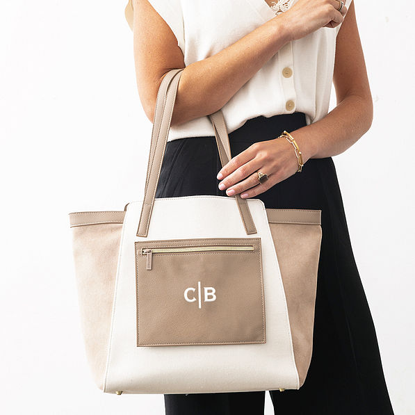 taupe colorblock tote bag on arm with split initials