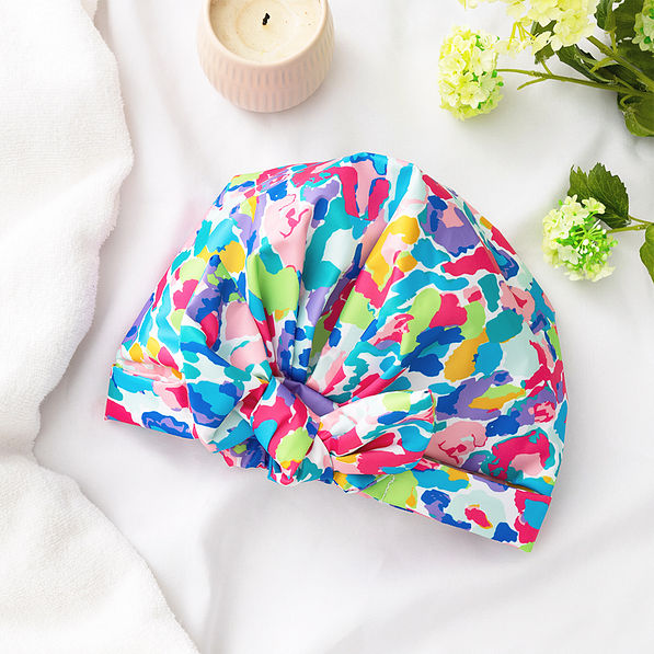 watercolor cheetah reusable shower cap flatlay