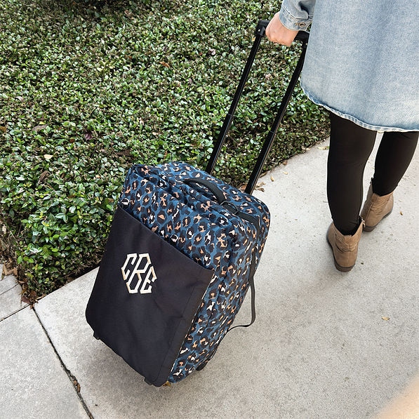 sapphire leopard rolling duffel bag on sidewalk