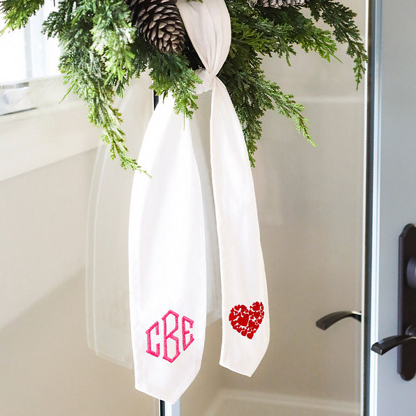 pink monogram on wreath sash with red hearts icon on the other side