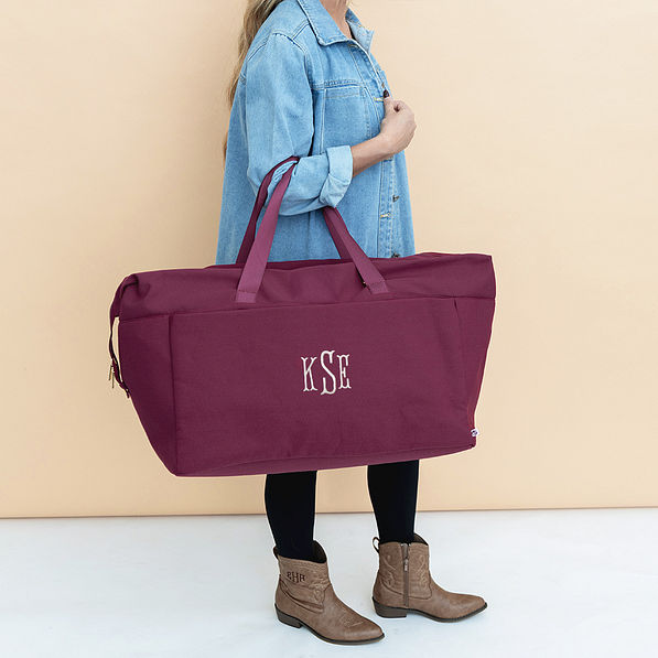 burgundy woodland blossom foldover weekend bag on arm