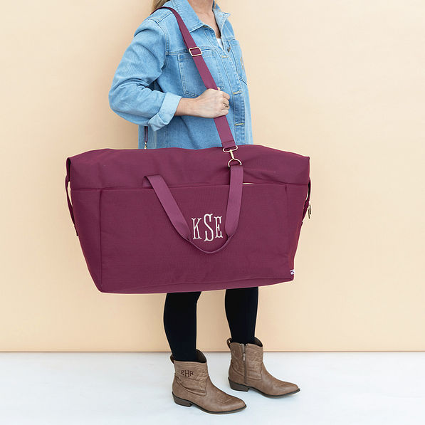 burgundy woodland blossom foldover weekend bag on shoulder