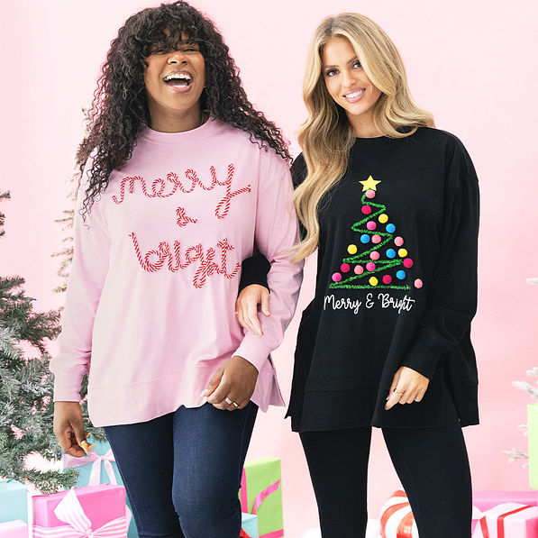 girls wearing light pink and black merry and bright sweatshirts