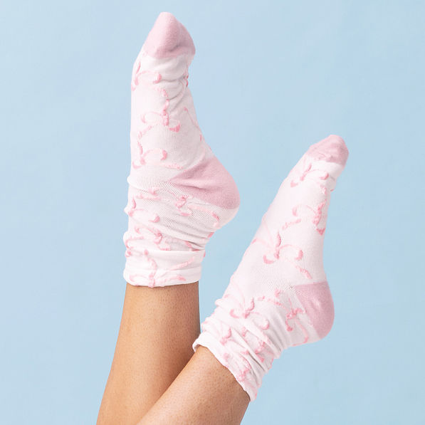 pink bow white socks on blue background