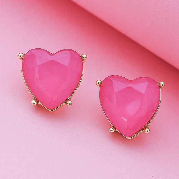 heart stud earrings on pink paper