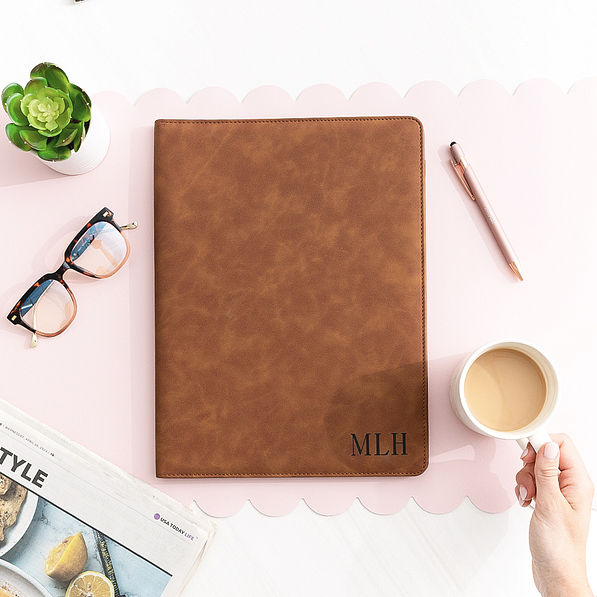 monogrammed leather portfolio on desk