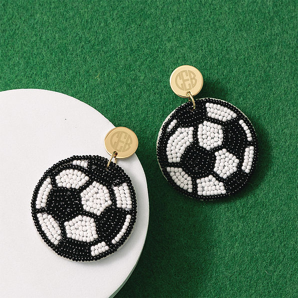 monogrammed soccer earrings on turf background