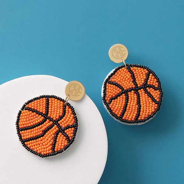 monogrammed basketball earrings on blue background