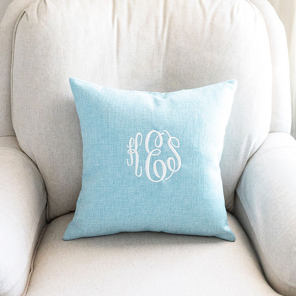 light blue linen pillow case on neutral chair