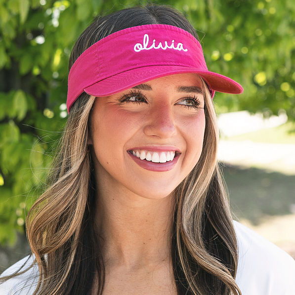 girl wearing monogrammed pink visor with name