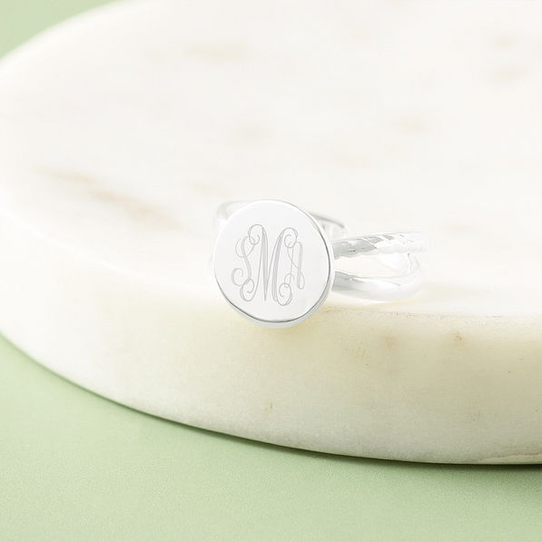 silver criss cross ring in marble dish