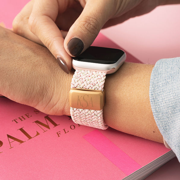 pink monogrammed smart watch band on wrist