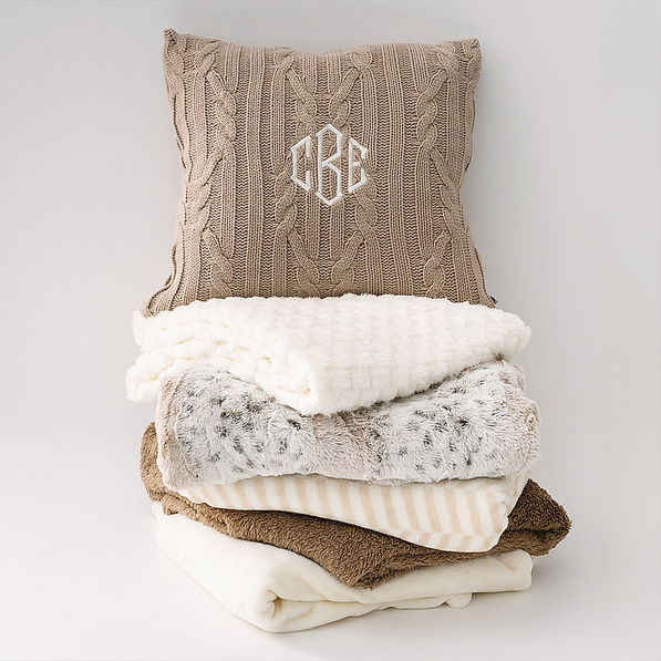 tan cable knit pillow sham on blanket stack