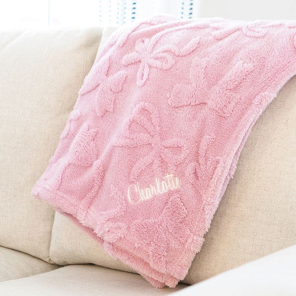 pink bow blanket on couch