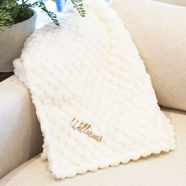 ivory textured plush blanket on couch