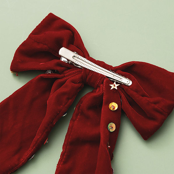 back of christmas velvet bow on green
