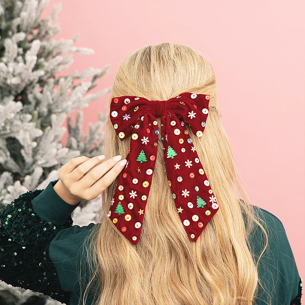 girl wearing christmas velvet bow back