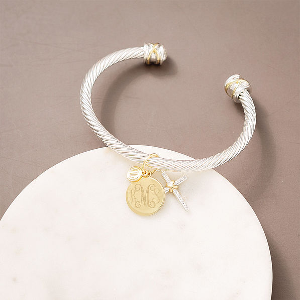 cable cross bracelet on marble dish