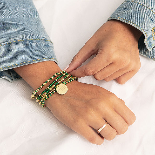 green gameday bracelet on wrist