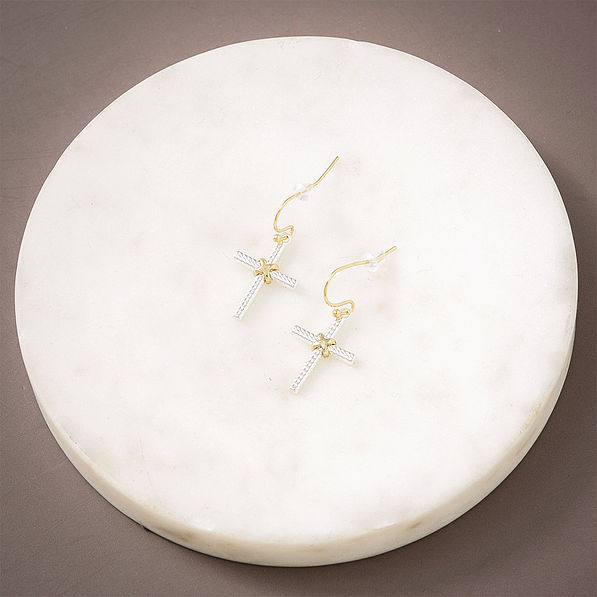 Cable cross earrings on marble dish