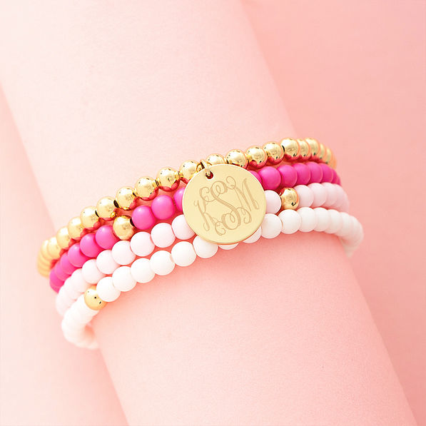 pink beaded bracelet set on pink background
