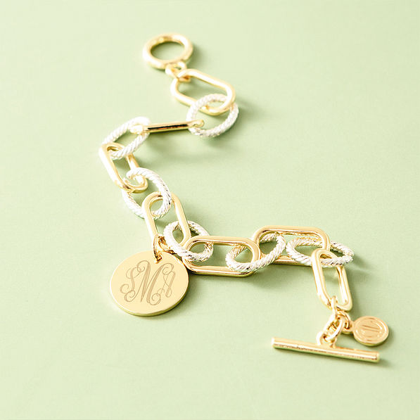 mixed metal chainlink bracelet on green background