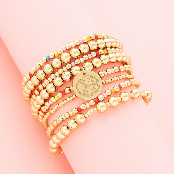 Colorful bracelet stack on pink