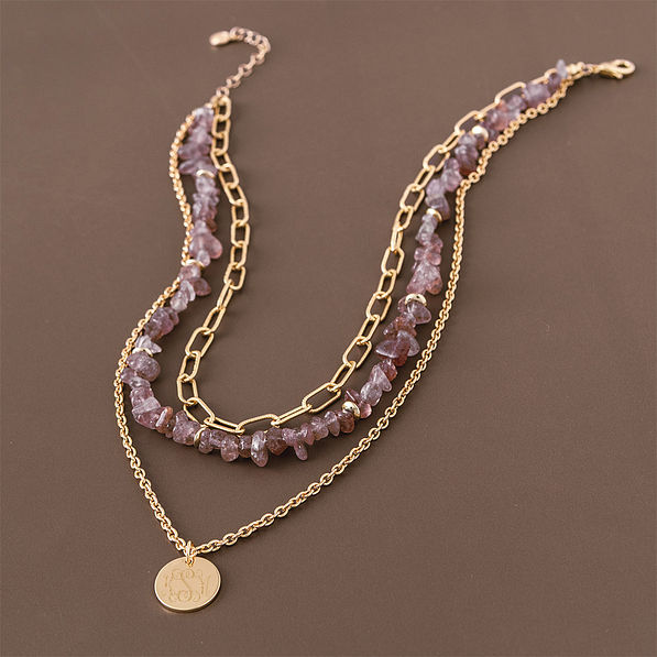 monogrammed triple layer necklace on brown background